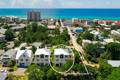 an aerial view of a neighborhood with houses and the ocean at The Suite Life on 30A in Santa Rosa Beach