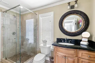 a bathroom with a shower and a toilet and a sink at Big Kahuna Beach House in Santa Rosa Beach