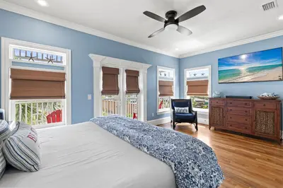 a bedroom with a bed and a ceiling fan at Big Kahuna Beach House in Santa Rosa Beach