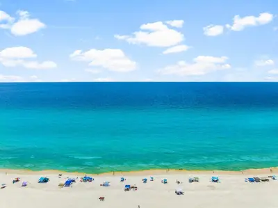 a view of a beach with umbrellas and the ocean at Location! Studio Condo Panama City Beach, Holiday Beach, Tents Allowed! in Panama City Beach