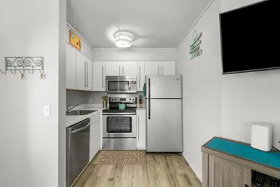 a kitchen with stainless steel appliances and white cabinets at Location! Studio Condo Panama City Beach, Holiday Beach, Tents Allowed! in Panama City Beach
