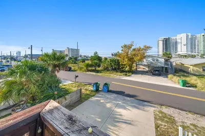 a view of a city street from a balcony at *NEW* Arcade Games & Steps to Beach! | 1800+ Sq Ft in Panama City Beach