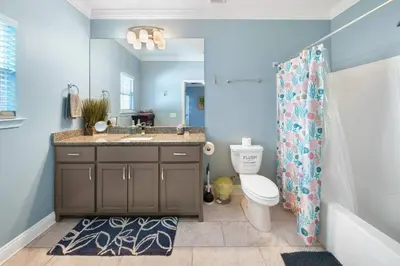 a bathroom with a sink and a toilet and a shower at *NEW* Arcade Games & Steps to Beach! | 1800+ Sq Ft in Panama City Beach