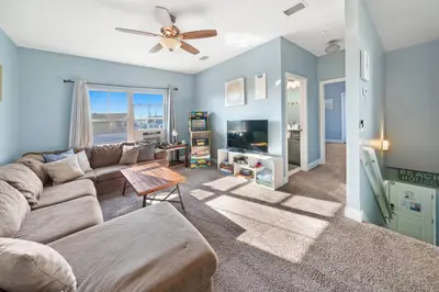 a living room with a couch and a tv at *NEW* Arcade Games & Steps to Beach! | 1800+ Sq Ft in Panama City Beach
