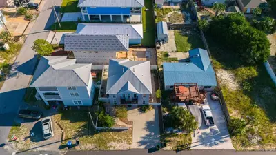 an overhead view of a house with blue roofs at *NEW* Arcade Games & Steps to Beach! | 1800+ Sq Ft in Panama City Beach
