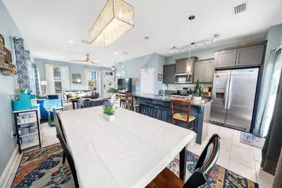 a kitchen and dining room with a table and a kitchen and a living room at *NEW* Arcade Games & Steps to Beach! | 1800+ Sq Ft in Panama City Beach