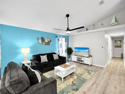 a living room with a couch and a tv at 1.2 mi to Beach | 15min to Pier Park | Pool Access in Panama City Beach