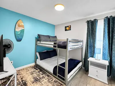 a bedroom with two bunk beds with blue walls at 1.2 mi to Beach | 15min to Pier Park | Pool Access in Panama City Beach