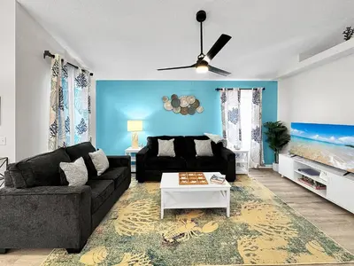 a living room with a couch and a table at 1.2 mi to Beach | 15min to Pier Park | Pool Access in Panama City Beach