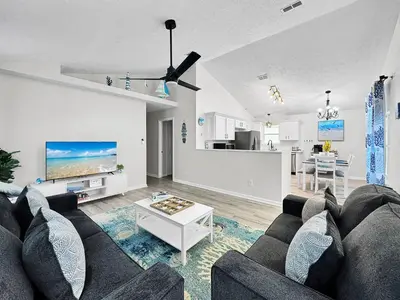 a living room with a couch and a table at 1.2 mi to Beach | 15min to Pier Park | Pool Access in Panama City Beach