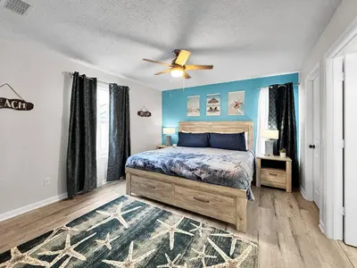 a bedroom with a bed and a ceiling fan at 1.2 mi to Beach | 15min to Pier Park | Pool Access in Panama City Beach