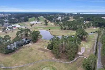 an overhead view of a golf course with a pond at Kid's Playground & Pool! | Spring Getaway! in Panama City Beach