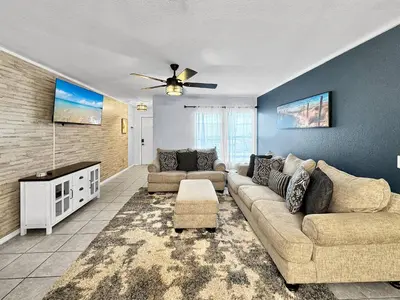 a living room with two couches and a ceiling fan at Kid's Playground & Pool! | Spring Getaway! in Panama City Beach