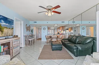a living room with a couch and a ceiling fan at Commodore 1306 in Panama City Beach