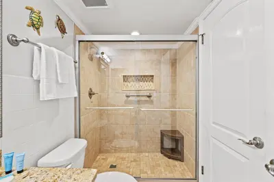 a bathroom with a shower and a toilet at Commodore 1106 in Panama City Beach