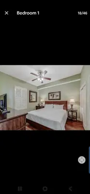 a bedroom with a bed and a ceiling fan at Grandview East in Panama City Beach