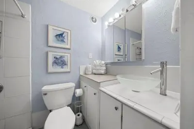 a bathroom with a white toilet and a sink at Beach Front Ocean View Condo - Top of the Gulf 615 in Panama City Beach