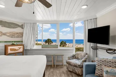 a bedroom with a bed and a view of the ocean at Beachfront Studio Condo - Top of the Gulf 317 in Panama City Beach