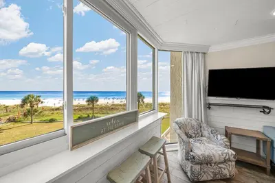 a living room with a view of the ocean at Beachfront Studio Condo - Top of the Gulf 317 in Panama City Beach