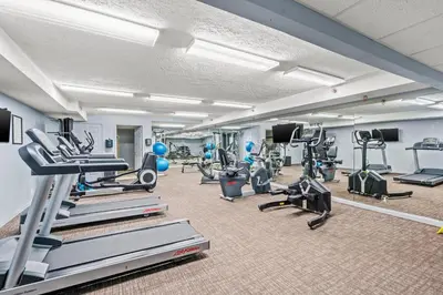 a gym with treadmills and machines in a room at It Doesn’t Get Any Better Than This! 2BR 2BA Sleeps 8 Beachfront! in Panama City Beach