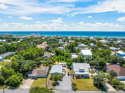 an aerial view of a neighborhood with houses and the ocean at Pet Friendly Beach House - Shore Nuff Beachy by Panhandle Getaways in Panama City Beach