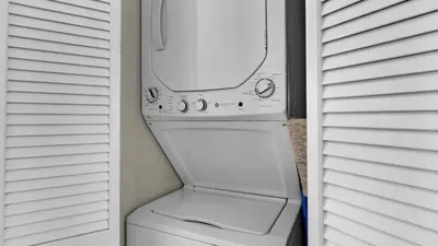 a white washer and dryer in a closet at Palms B4 in Santa Rosa Beach