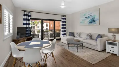 a living room with a couch and a table and chairs at Palms B4 in Santa Rosa Beach