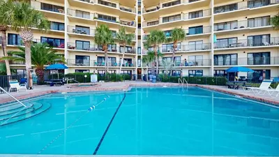 a large swimming pool in front of a building at Commodore 0608 in Panama City Beach