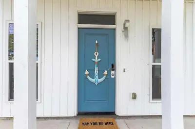 a blue door with an anchor on it on a house at Sunny Daze by Emerald Coast Retreats in Panama City Beach