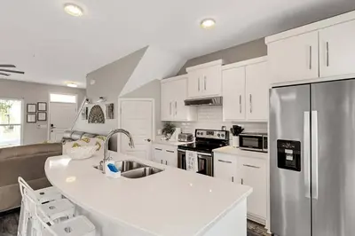 a kitchen with white cabinets and a white counter top at Sunny Daze by Emerald Coast Retreats in Panama City Beach