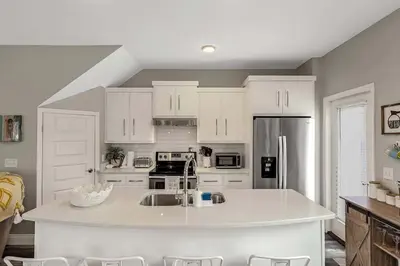 a kitchen with white cabinets and a white counter top at Sunny Daze by Emerald Coast Retreats in Panama City Beach