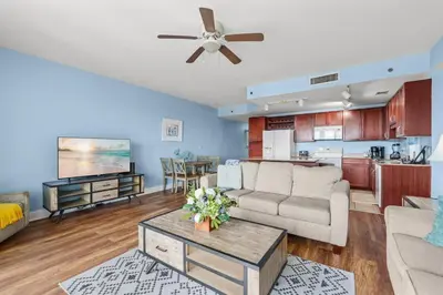 a living room with a couch and a table at Bright & Spacious Condo 1BD! Steps from the Beach! by Dolce Vita Getaways PCB in Panama City Beach