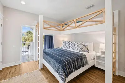 a bedroom with a bed and a balcony at Fore Seasons by 30A Escapes in Seagrove Beach