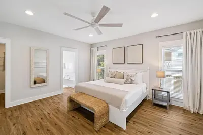 a white bedroom with a bed and a ceiling fan at Fore Seasons by 30A Escapes in Seagrove Beach