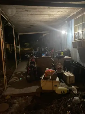 a dark room with a garage with a motorcycle in it at Beach bum in Panama City Beach