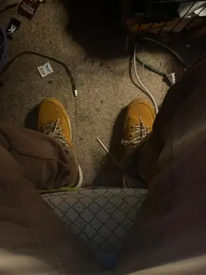 a person with yellow shoes on the floor at Beach bum in Panama City Beach
