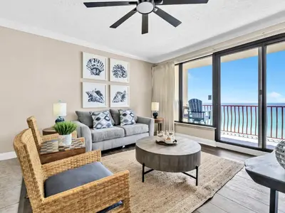 a living room with a couch and a table at Hidden Dunes 704 in Panama City Beach