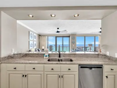 a kitchen with a sink and a large window at Hidden Dunes 704 in Panama City Beach