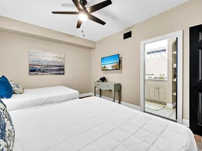 a bedroom with two beds and a ceiling fan at Hidden Dunes 704 in Panama City Beach