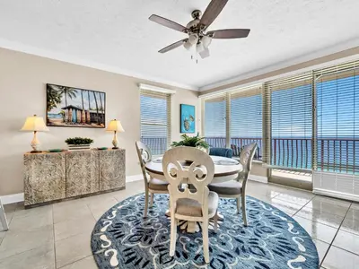 a dining room with a table and chairs and a ceiling fan at Hidden Dunes 1705 in Panama City Beach