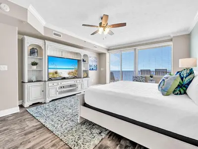 a bedroom with a large bed and a tv at Hidden Dunes 1705 in Panama City Beach