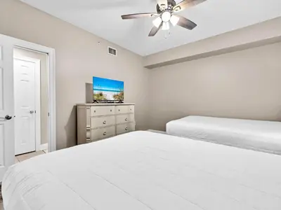 a bedroom with two beds and a ceiling fan at Hidden Dunes 1705 in Panama City Beach