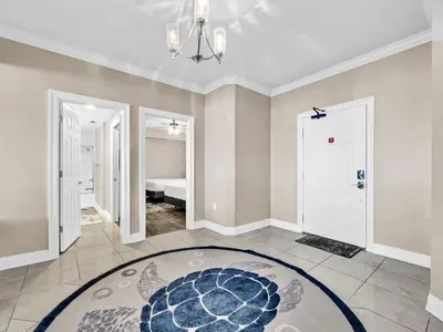 a living room with a large rug on the floor at Hidden Dunes 1705 in Panama City Beach