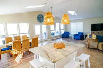 a living room with a table and chairs at Lagoon Landing Waterfront Home in Panama City Beach