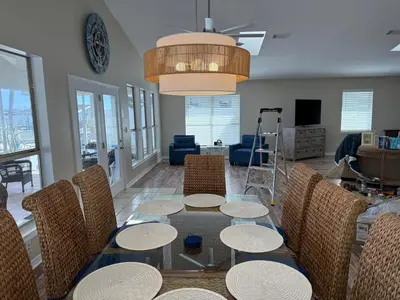 a dining room with a table and chairs at Lagoon Landing Waterfront Home in Panama City Beach