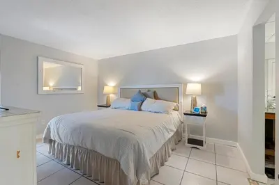 a bedroom with a large bed with two lamps at 1007 Edgewater T1 Beach Resort in Panama City Beach