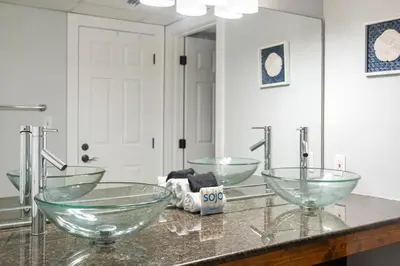 a bathroom with two bowl sinks and a mirror at 1007 Edgewater T1 Beach Resort in Panama City Beach