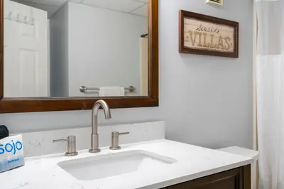 a bathroom with a sink and a mirror at 1007 Edgewater T1 Beach Resort in Panama City Beach