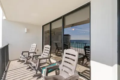 a row of chairs sitting on a balcony at 1007 Edgewater T1 Beach Resort in Panama City Beach
