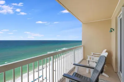 a balcony with two chairs and the ocean at 1202 Seychelles in Panama City Beach